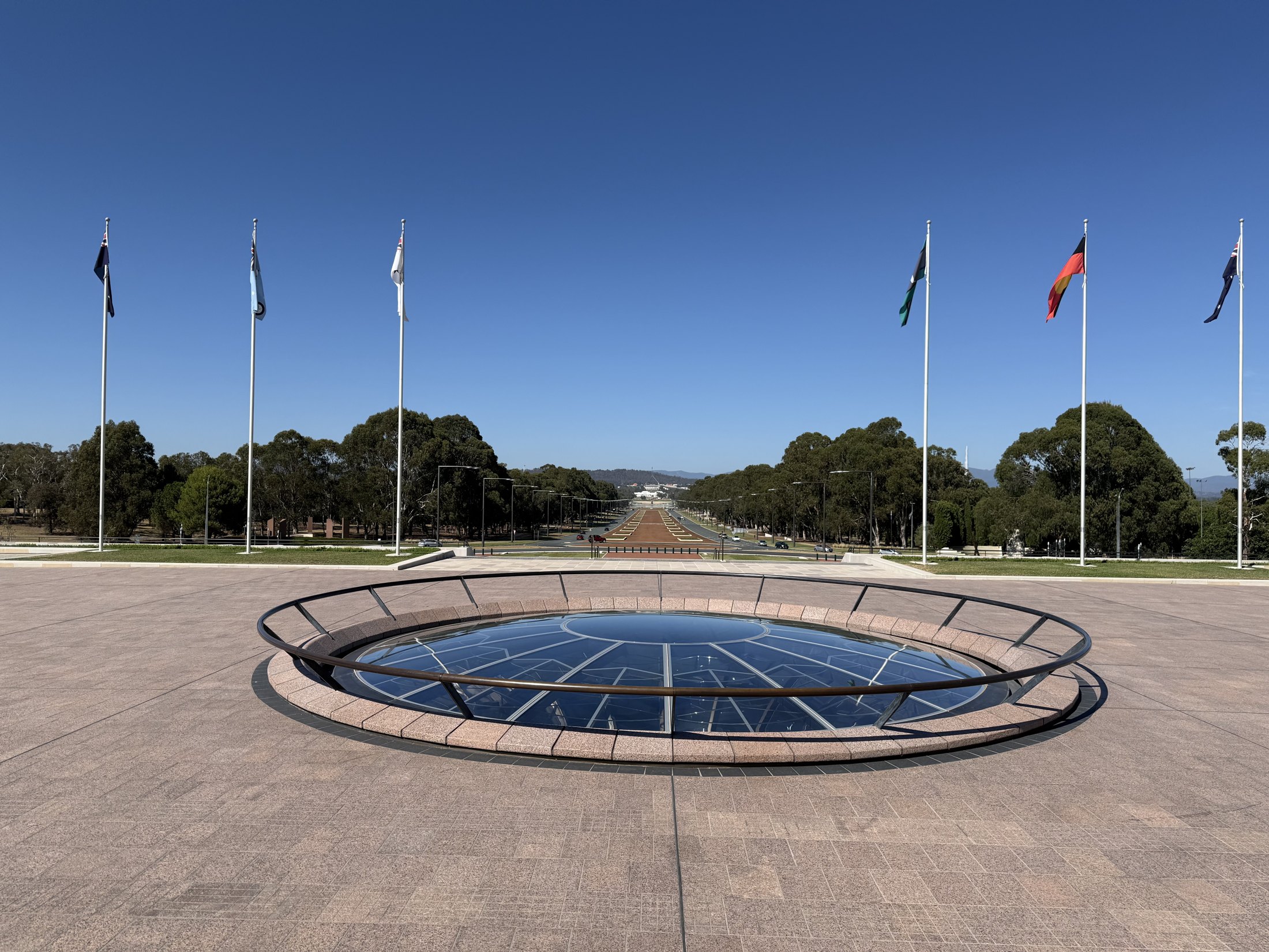 View south from the Australian War Memorial down ANZAC Parade towards Old Parliament House and Parliament House across Lake Burley Griffin.